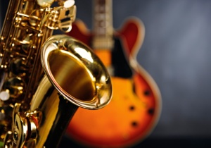 Close up on saxophone with guitar in background. Jazz rules!